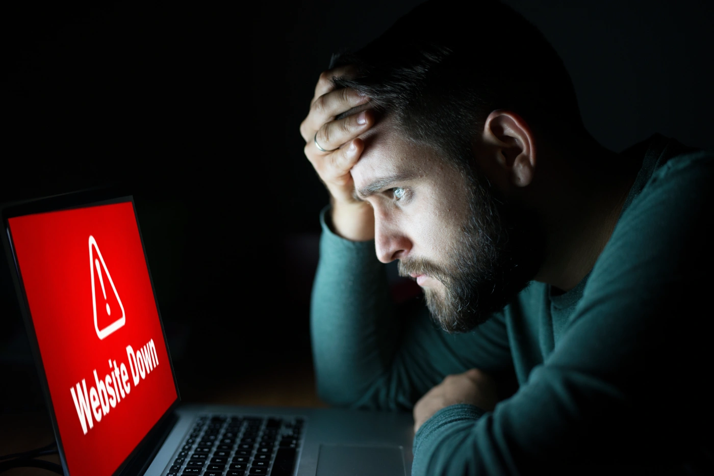 Business owner looking worried at website error notifications on a laptop while technical maintenance alerts appear on screen.